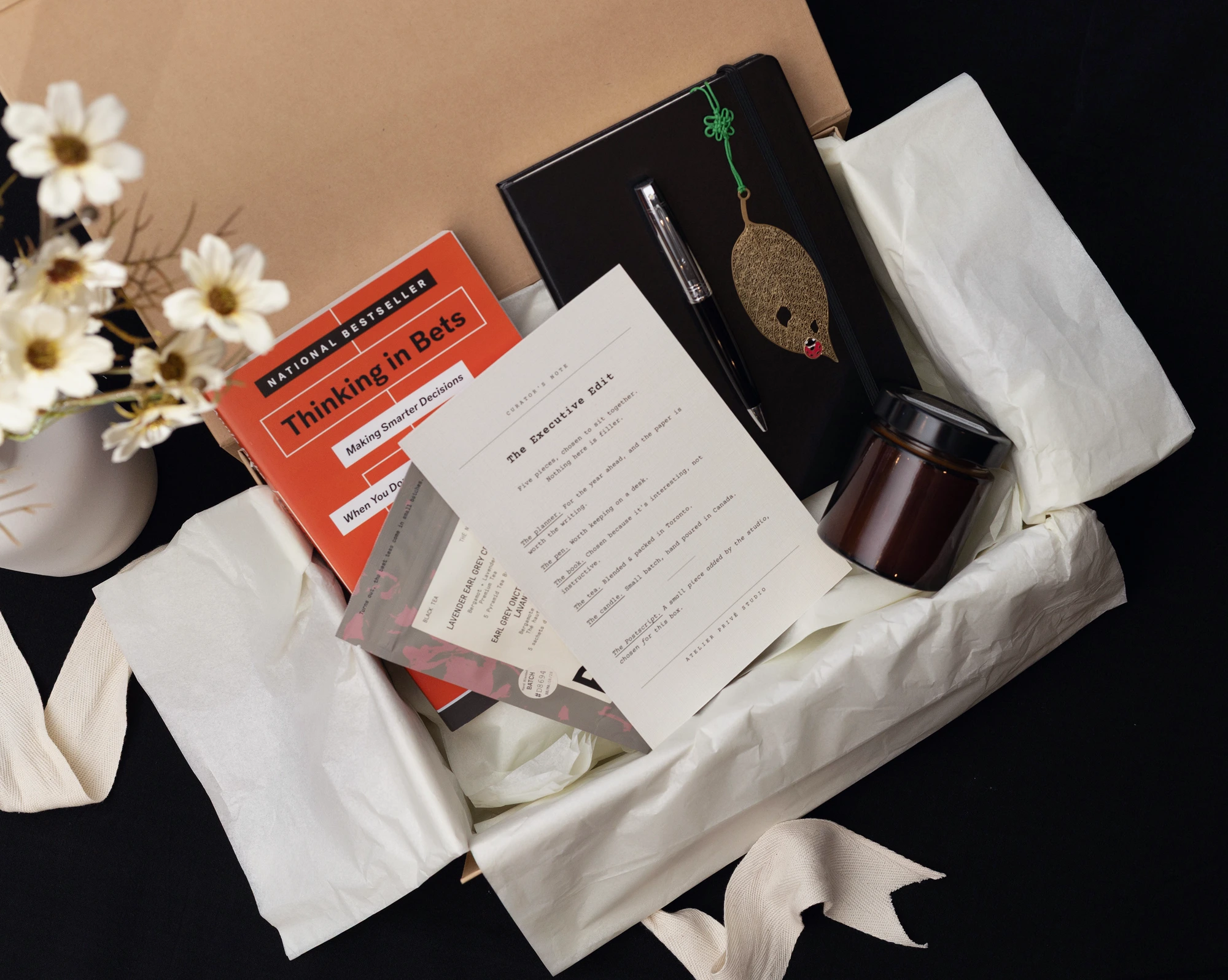 The Executive Edit with planner, pen, book, tea, candle and Curator’s Note in a gift box
