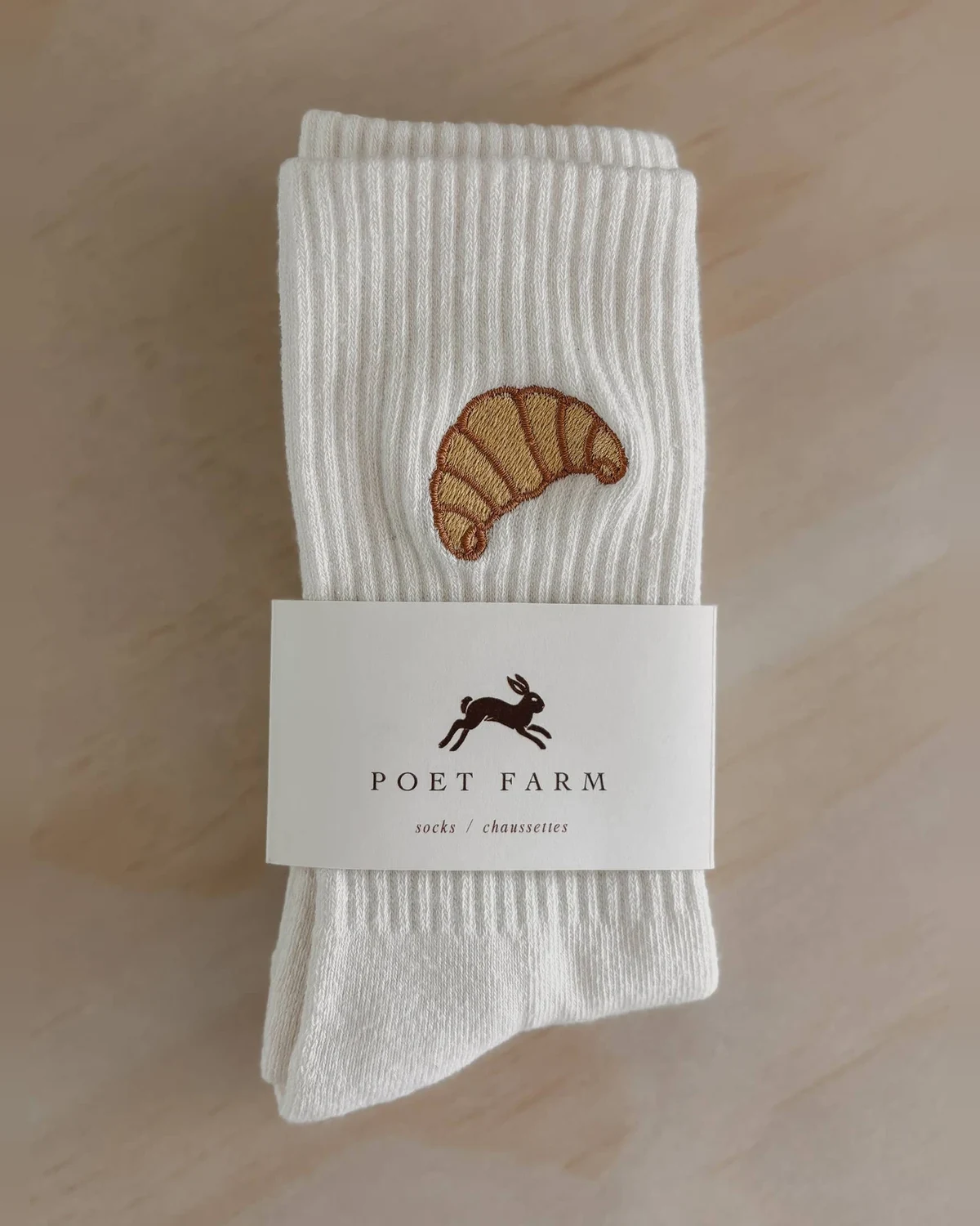 Poet Farm off-white ribbed socks with embroidered croissant and paper band