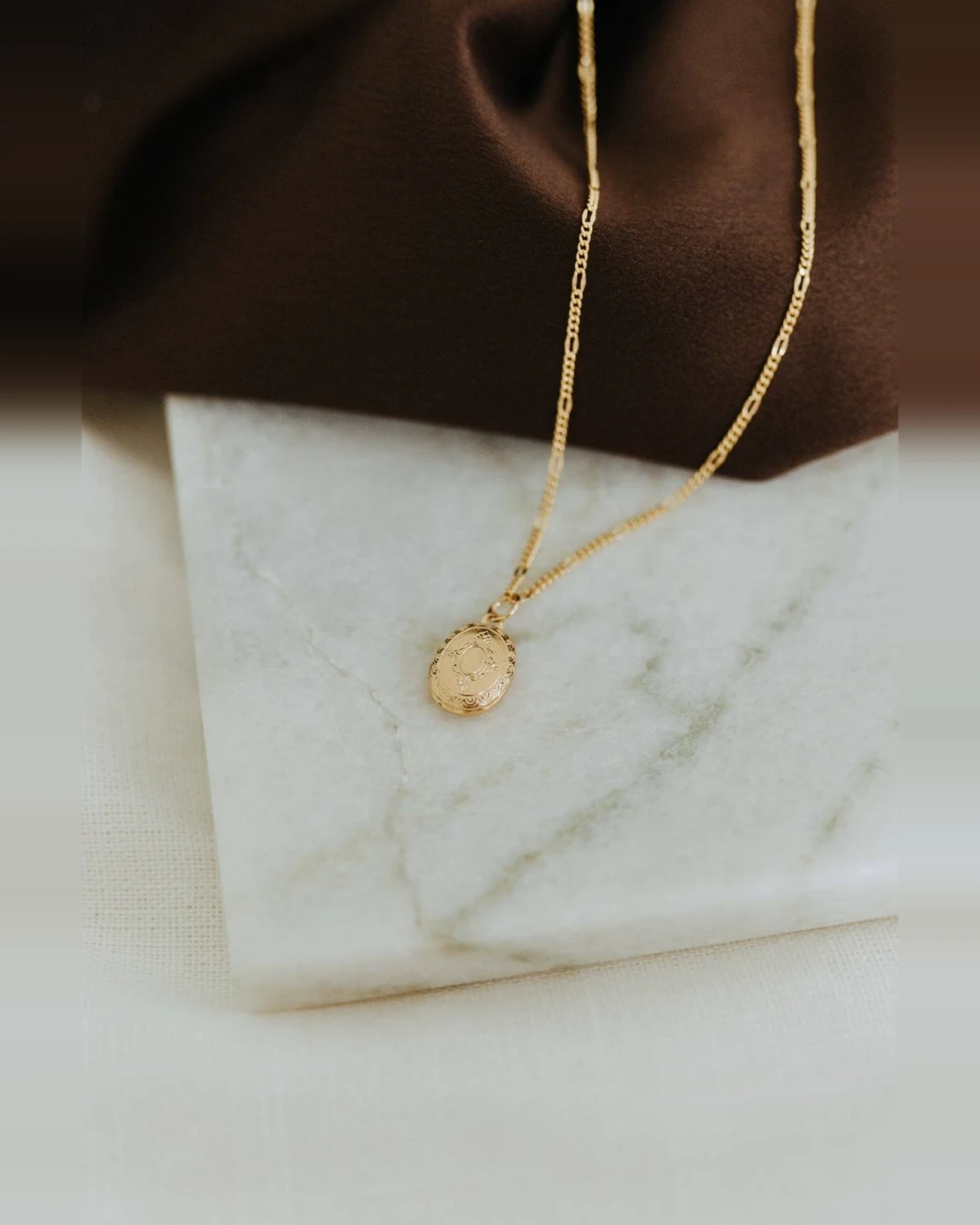 Sydney Rose Co. Mini Oval Locket Necklace on its lace chain